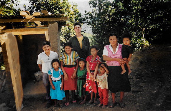 Sam C Jeremy standing behind Hondurans